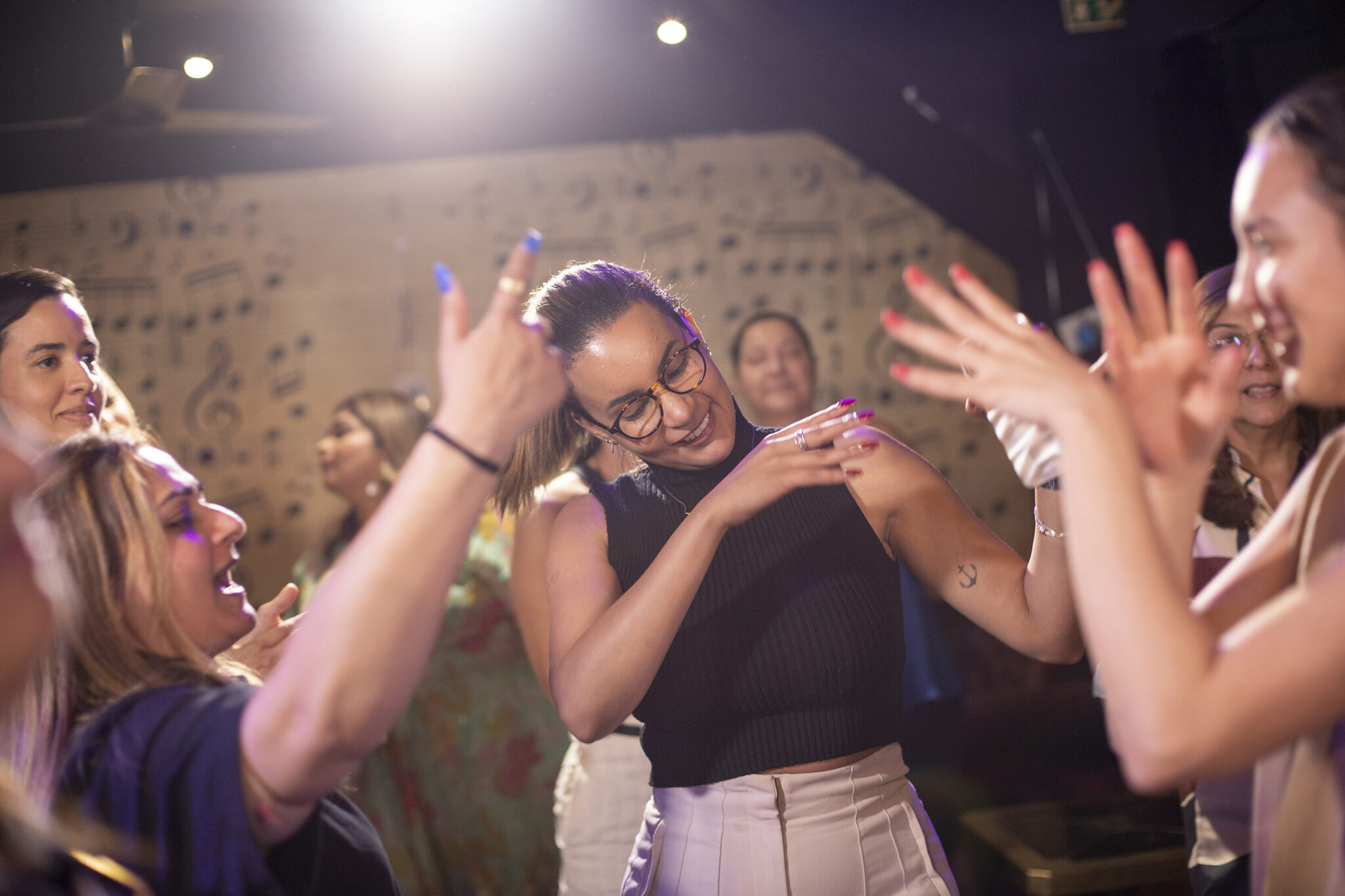 Women dancing and enjoying themselves at a lively indoor party.