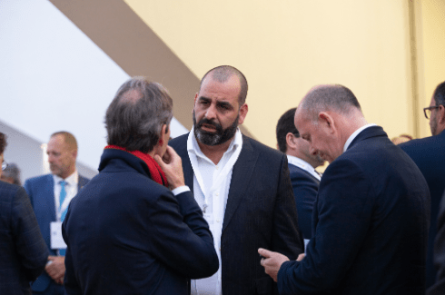 Business professionals networking at a corporate event, engaging in conversation and exchanging ideas.