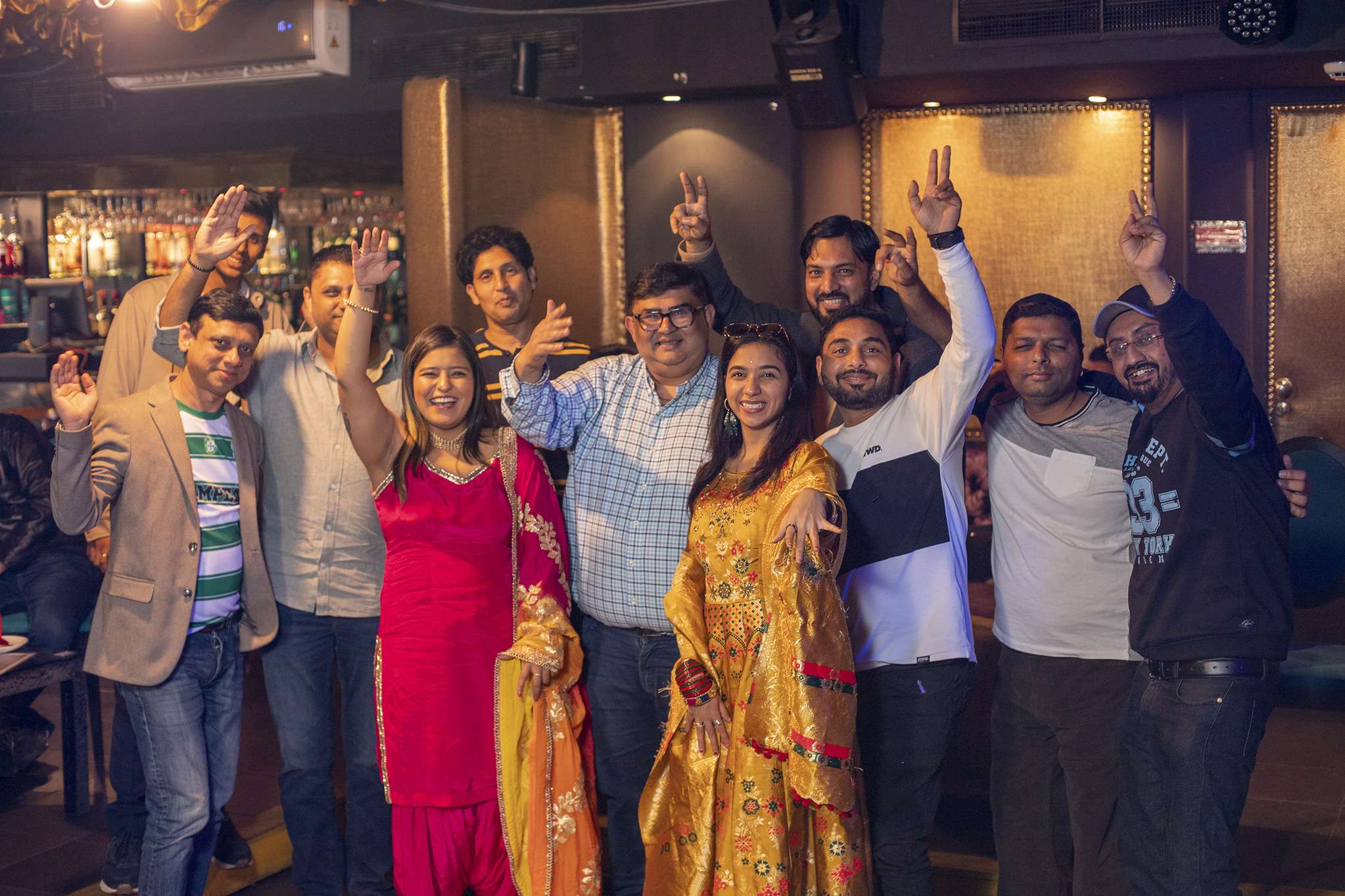 Group of people celebrating in a lively indoor party.